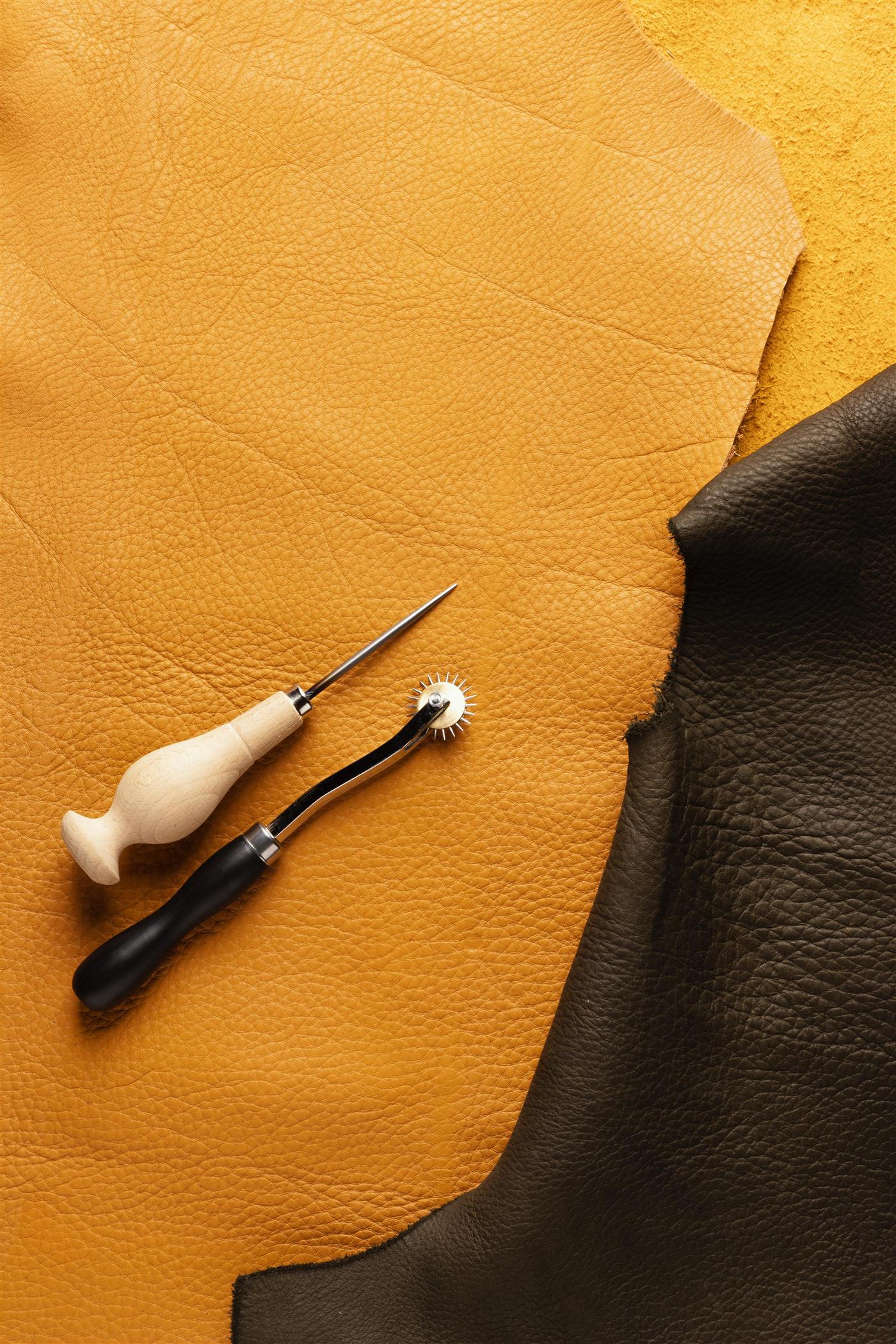 Thread, scissors and leather flat lay